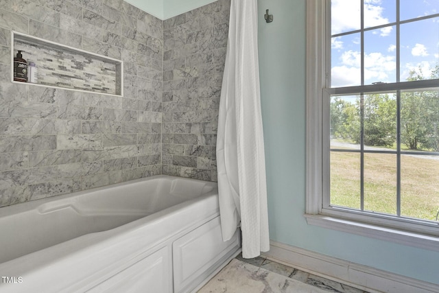 bathroom with shower / bath combination with curtain