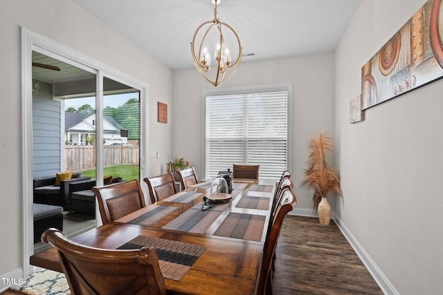 dining space featuring a notable chandelier, baseboards, and wood finished floors