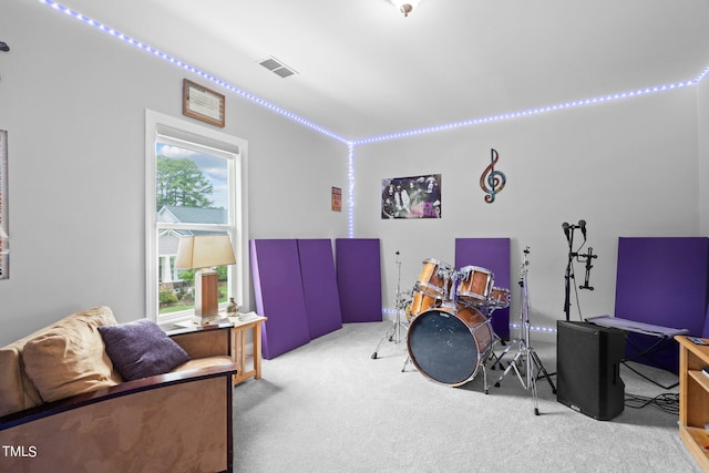 interior space with carpet floors and visible vents