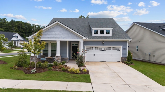 craftsman house featuring a garage, driveway, stone siding, a porch, and a front yard