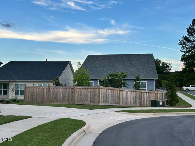 exterior space with a front lawn and fence