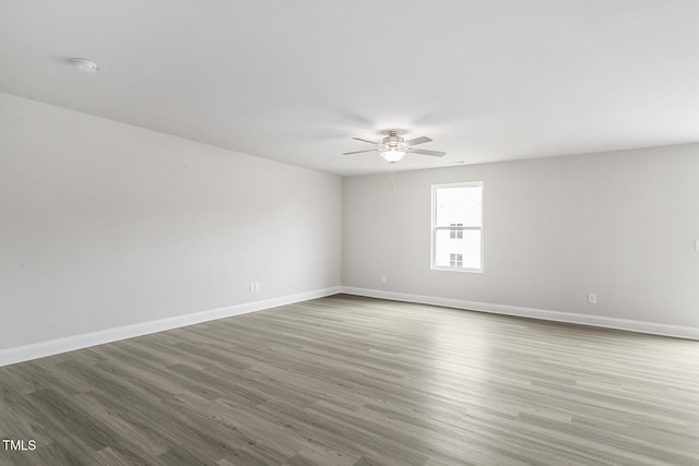 unfurnished room with hardwood / wood-style floors and ceiling fan