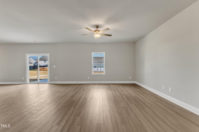 empty room featuring hardwood / wood-style flooring and ceiling fan