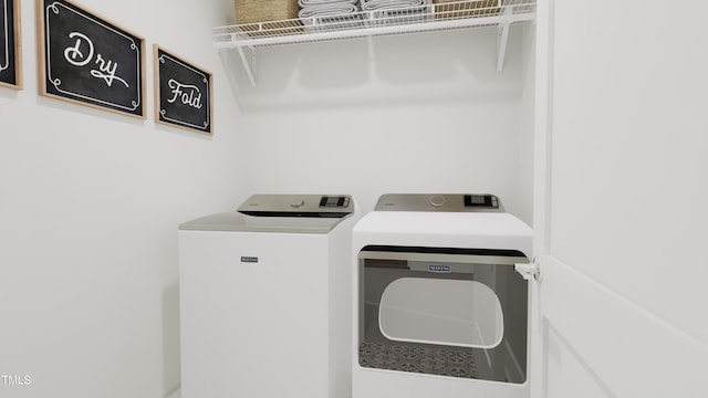 clothes washing area with washing machine and clothes dryer