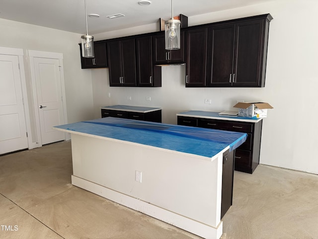 kitchen featuring decorative light fixtures and a kitchen island