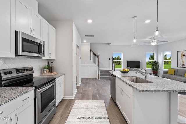 8816 Melvin St Unit 15-, Smithfield, Willow Springs, NC 27592 - kitchen with appliances with stainless steel finishes, open floor plan, a sink, a kitchen island with sink, and decorative backsplash