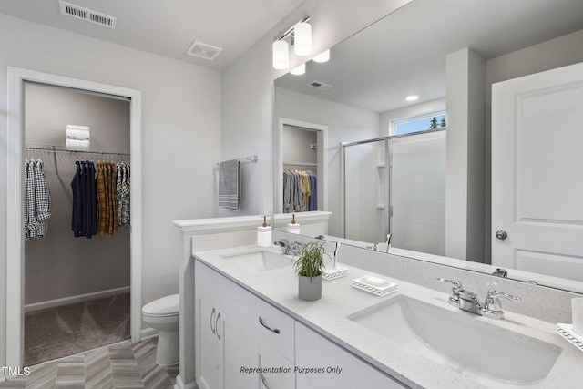 8816 Melvin St Unit 15-, Smithfield, Willow Springs, NC 27592 - bathroom featuring toilet, double vanity, a spacious closet, and a shower stall
