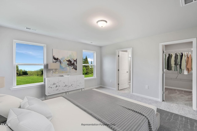8816 Melvin St Unit 15-, Smithfield, Willow Springs, NC 27592 - carpeted bedroom featuring baseboards and a walk in closet