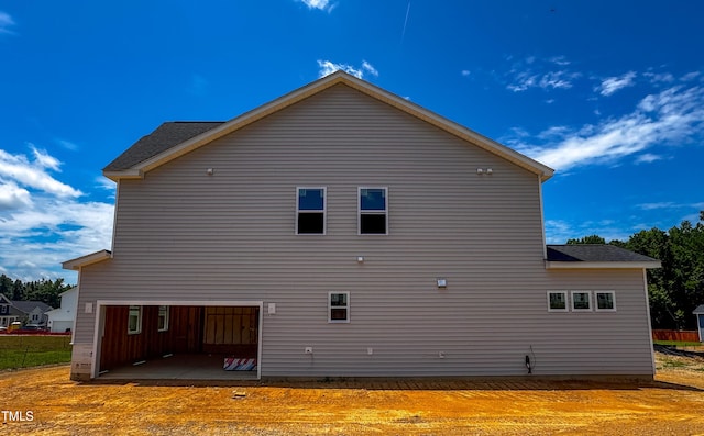 8816 Melvin St Unit 15-, Smithfield, Willow Springs, NC 27592 - view of side of property with a patio, a garage, and a shingled roof