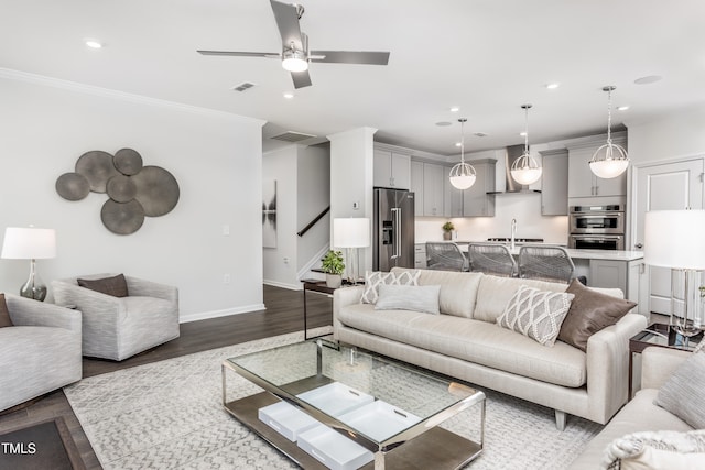 living area with stairs, ornamental molding, dark wood-style floors, and recessed lighting