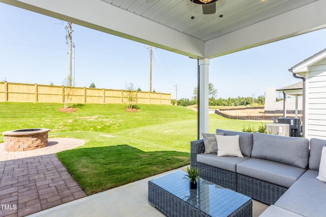 view of patio with a ceiling fan, an outdoor living space with a fire pit, and fence