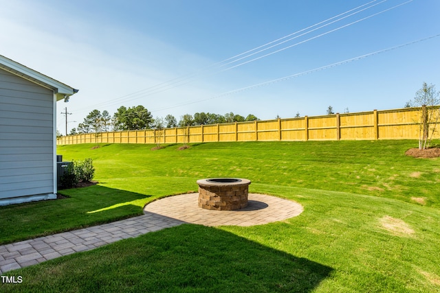 view of yard featuring an outdoor fire pit and fence