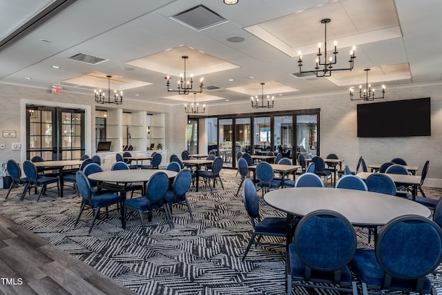 dining space featuring visible vents, ornamental molding, a notable chandelier, and french doors