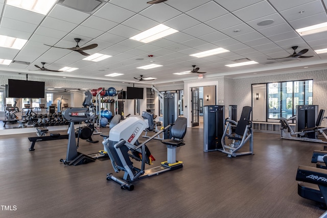 exercise room featuring a paneled ceiling, visible vents, and ceiling fan