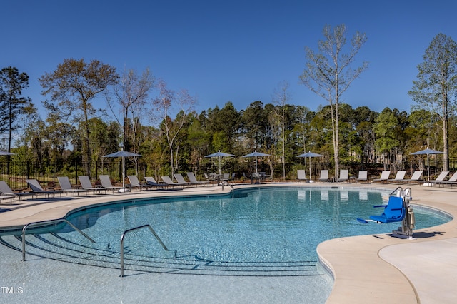 pool featuring a patio and fence