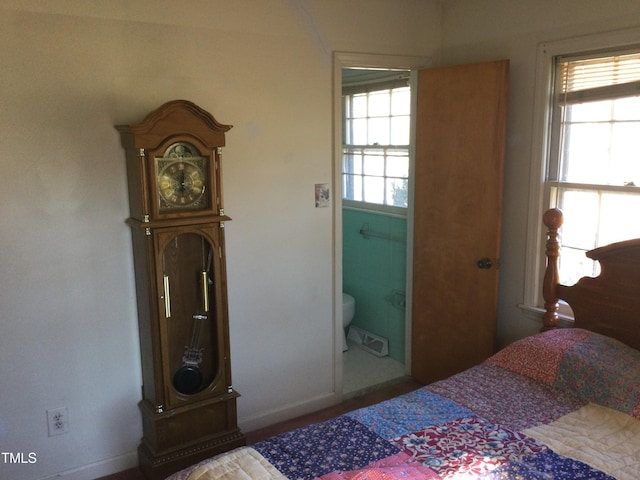 bedroom featuring connected bathroom and multiple windows