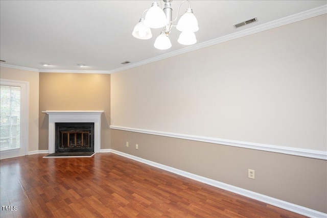 unfurnished living room with an inviting chandelier, ornamental molding, and hardwood / wood-style flooring