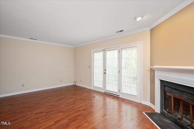 unfurnished living room featuring hardwood / wood-style floors and ornamental molding