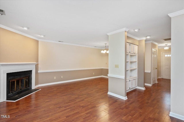 unfurnished living room with crown molding, dark hardwood / wood-style flooring, and a chandelier