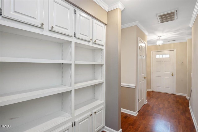 hallway featuring crown molding and dark hardwood / wood-style flooring