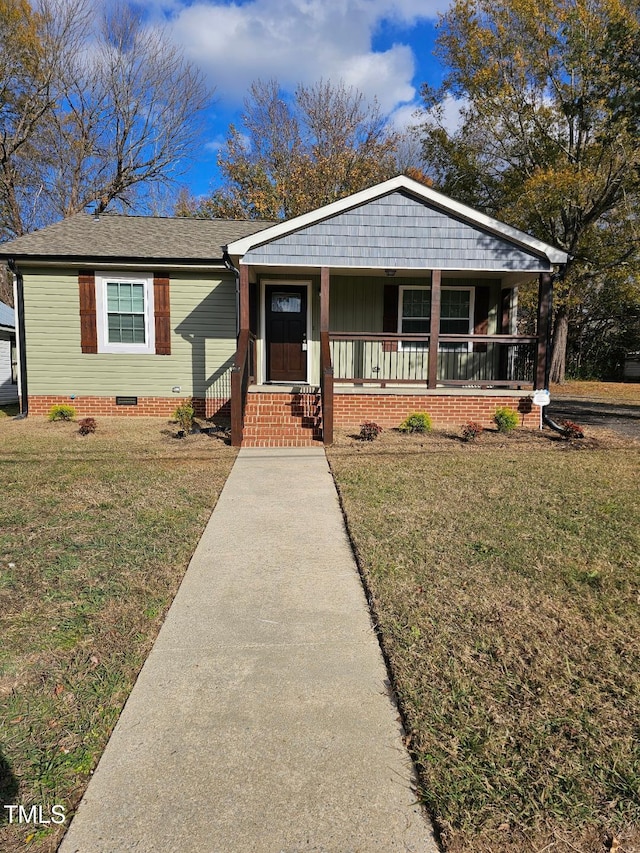 view of front of property with a porch and a front lawn