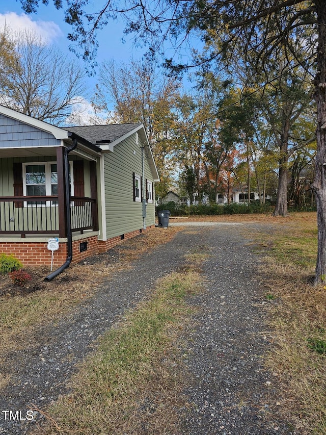 view of side of property featuring a porch