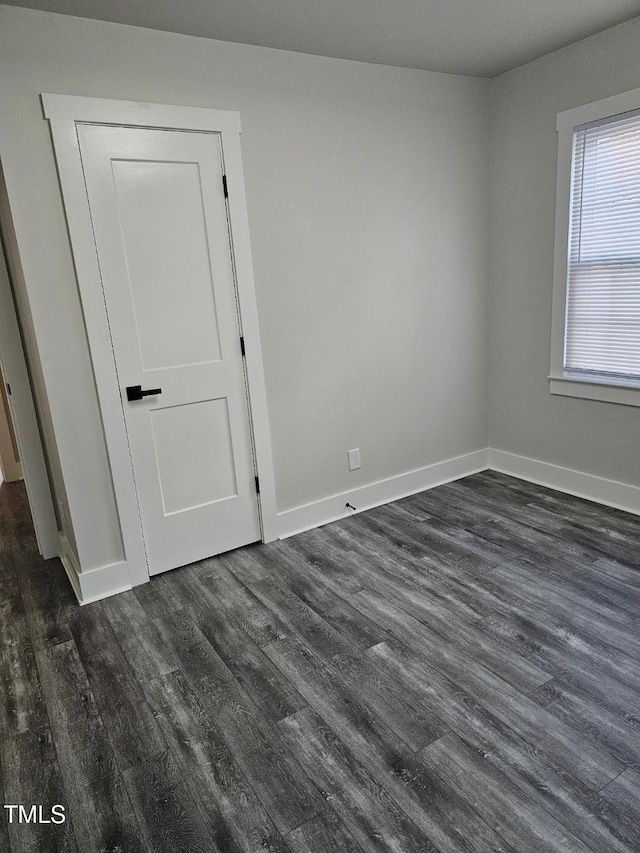 spare room with dark hardwood / wood-style flooring