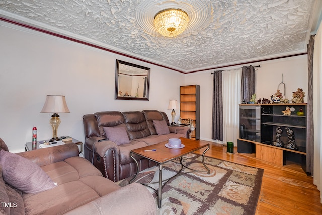 living room with ornamental molding, a textured ceiling, and hardwood / wood-style flooring