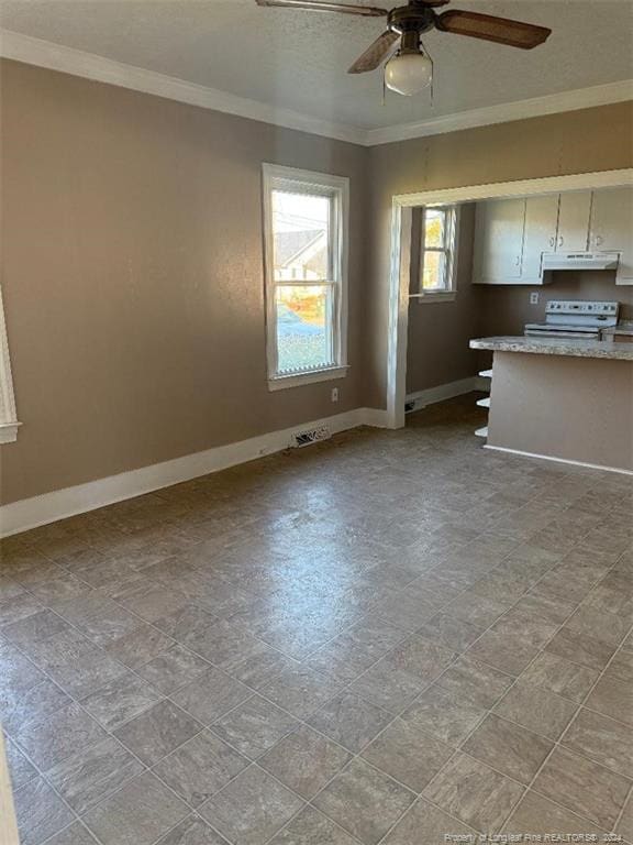 interior space with ceiling fan, white cabinets, ornamental molding, and white electric range