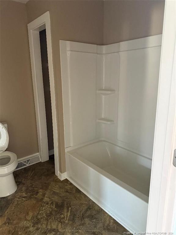 bathroom with shower / bath combination and toilet