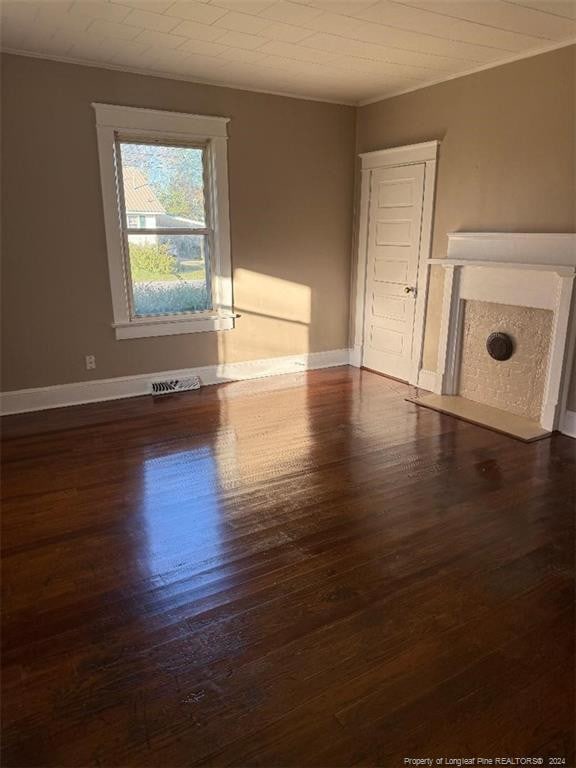 unfurnished living room with dark hardwood / wood-style floors