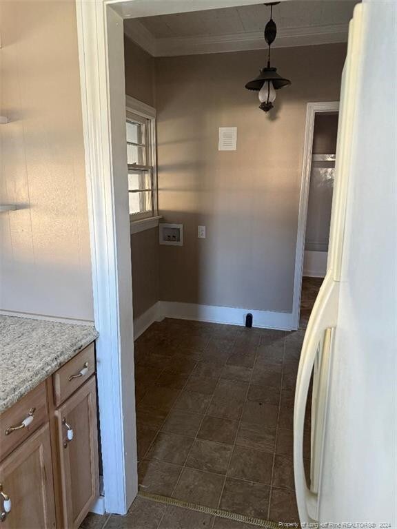 washroom with hookup for a washing machine and crown molding