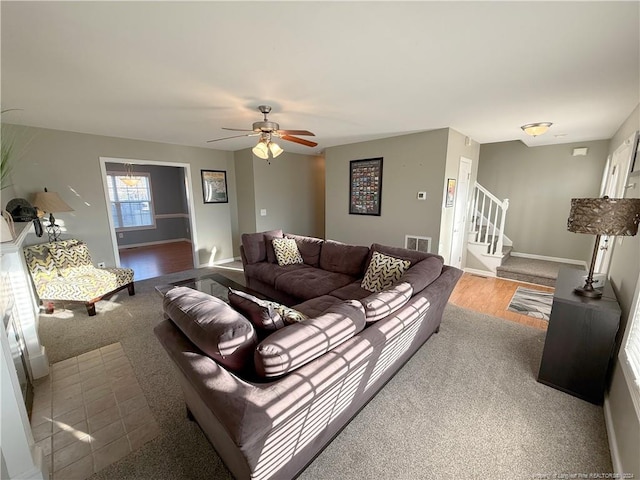 living room featuring light wood-type flooring and ceiling fan