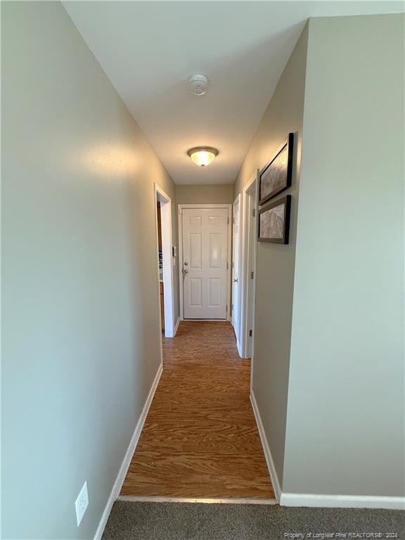 corridor with wood-type flooring