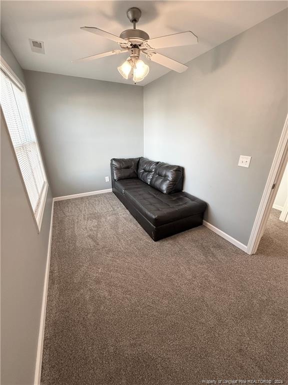 sitting room with carpet and ceiling fan