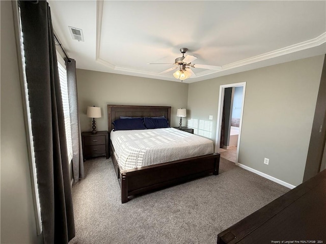 bedroom with carpet flooring, ceiling fan, crown molding, and a tray ceiling