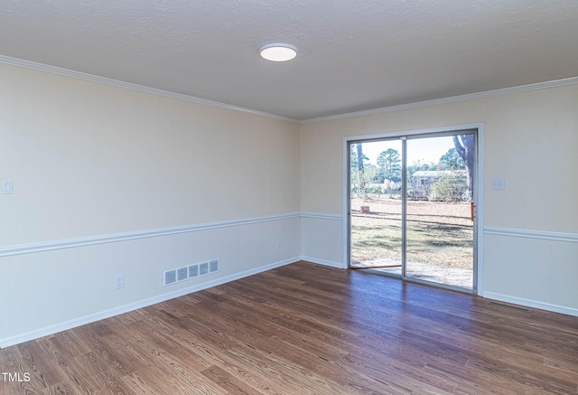 unfurnished room featuring a textured ceiling, crown molding, and dark wood-type flooring