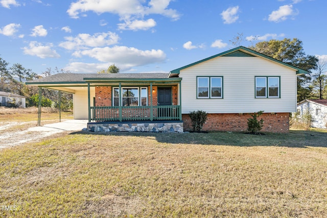 view of front of house with covered porch, a front yard, and a carport