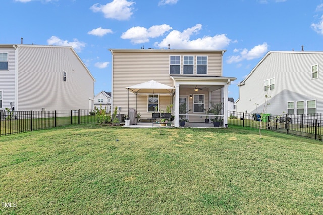 back of property with a sunroom, ceiling fan, a yard, and a patio