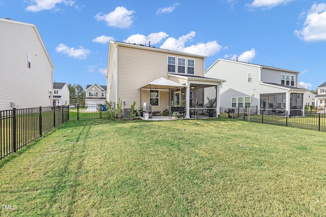 rear view of house featuring a sunroom, central air condition unit, a patio, and a lawn