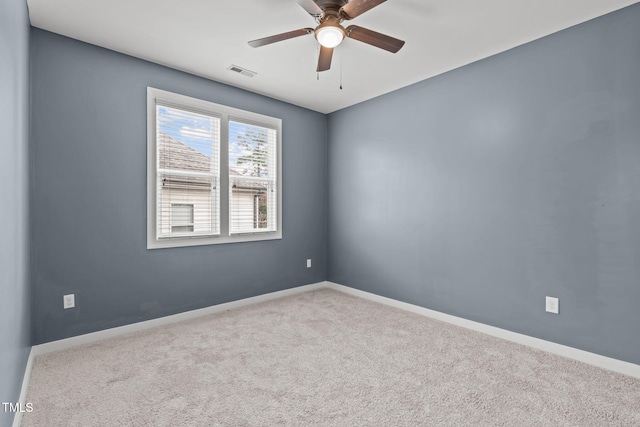 carpeted empty room featuring ceiling fan