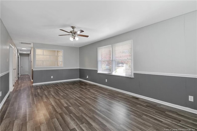 spare room featuring dark hardwood / wood-style floors and ceiling fan