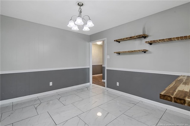 spare room featuring a notable chandelier