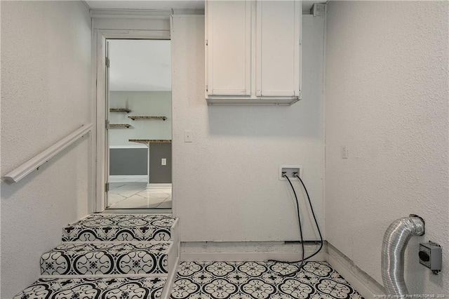 washroom with cabinets, washer hookup, and light tile patterned floors