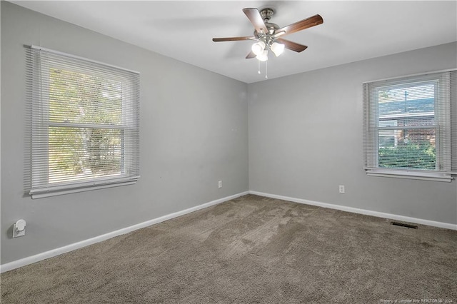 empty room featuring carpet flooring and ceiling fan