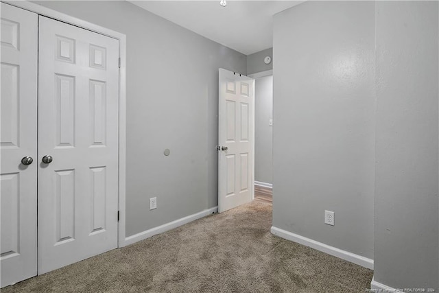 unfurnished bedroom featuring carpet floors and a closet