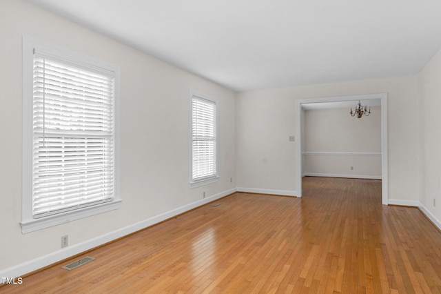 1204 Breedlove Rd, Nashville, NC 27856 - spare room featuring light wood-style flooring, a chandelier, and baseboards