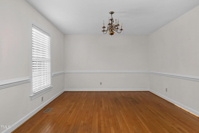 1204 Breedlove Rd, Nashville, NC 27856 - spare room with a chandelier, wood-type flooring, baseboards, and healthy amount of natural light