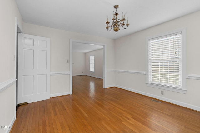 1204 Breedlove Rd, Nashville, NC 27856 - unfurnished dining area featuring a chandelier, wood-type flooring, and baseboards