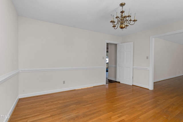 1204 Breedlove Rd, Nashville, NC 27856 - empty room featuring a chandelier, light wood finished floors, and baseboards